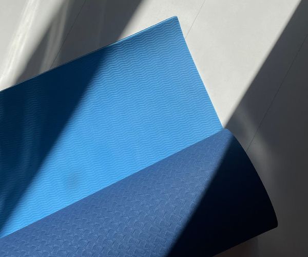 Minimalist room with yoga mat and soft sunlight